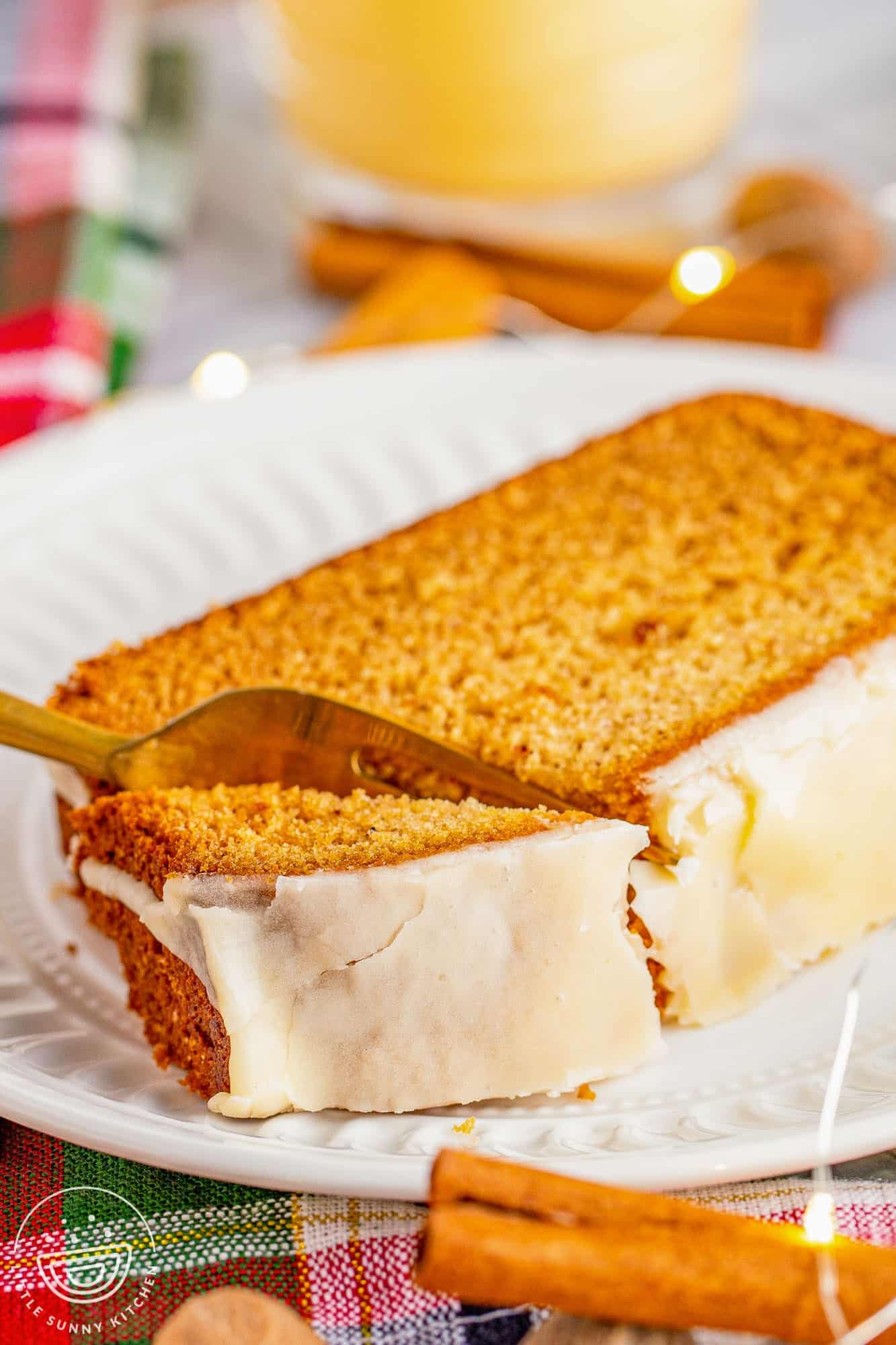 Bite shot of eggnog bread on a white plate