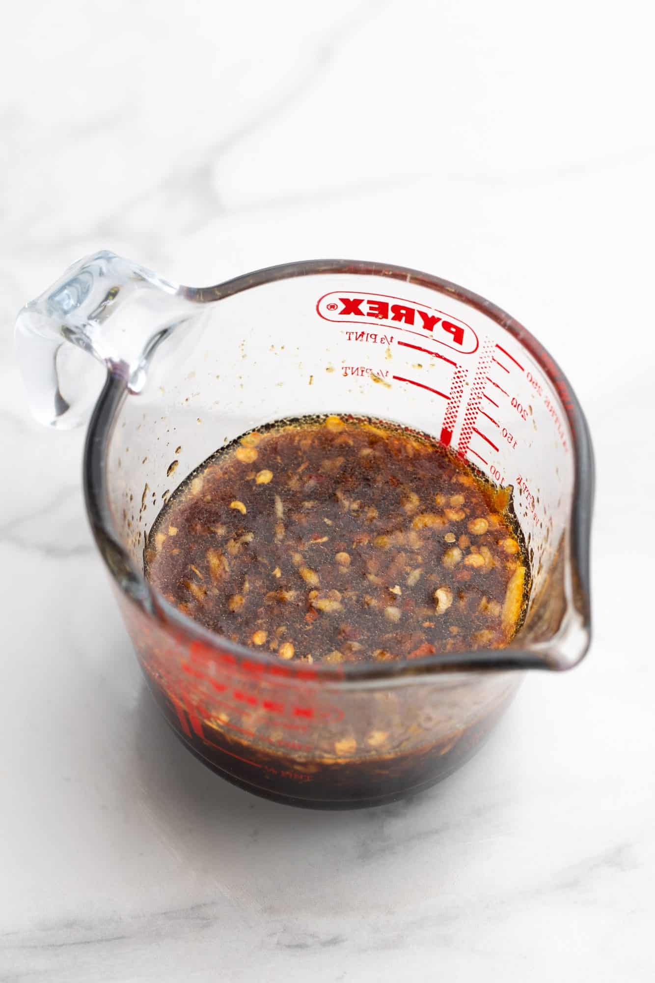 a pyrex measuring cup filled with sauce for making korean beef bowls.