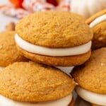 pumpkin whoopie pies piled on a plate.