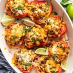 an oval casserole filled with cheese covered vegetaraian stuffed peppers.