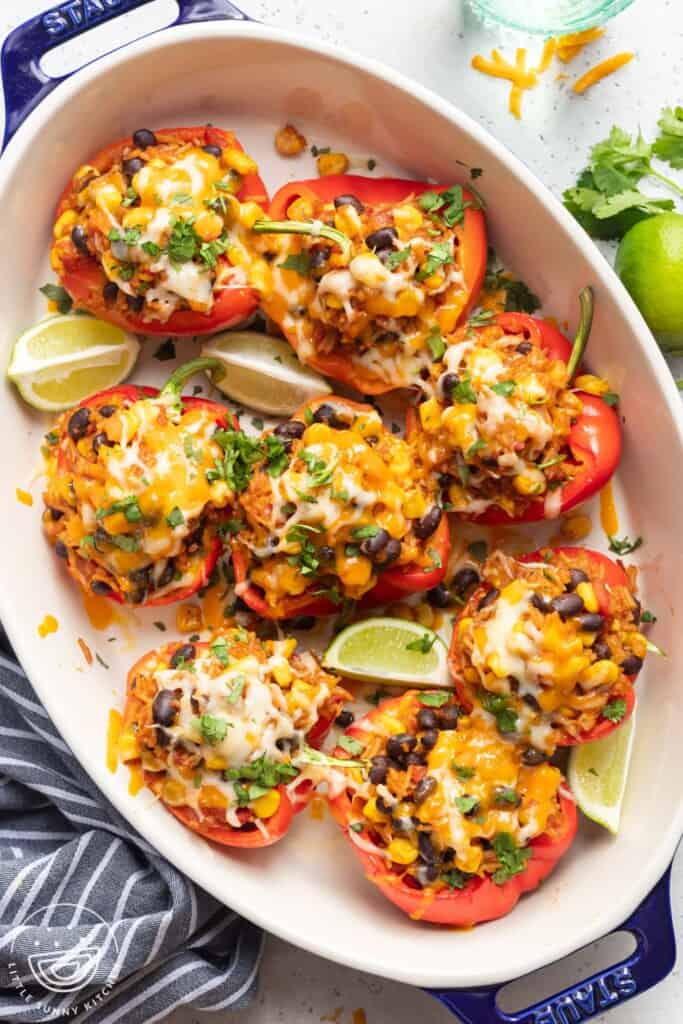 an oval casserole filled with cheese covered vegetaraian stuffed peppers.