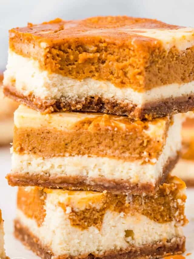 closeup shot of three layered pumpkin cheesecake squares.