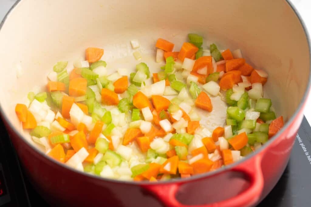 carrots, onion, celery sauteed in a red dutch oven.