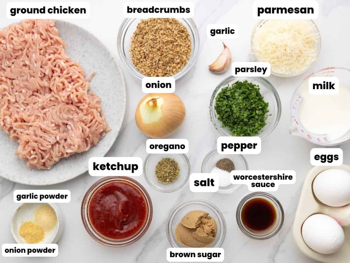 The ingredients needed to make ground chicken meatloaf, measured into bowls and arranged on a counter.