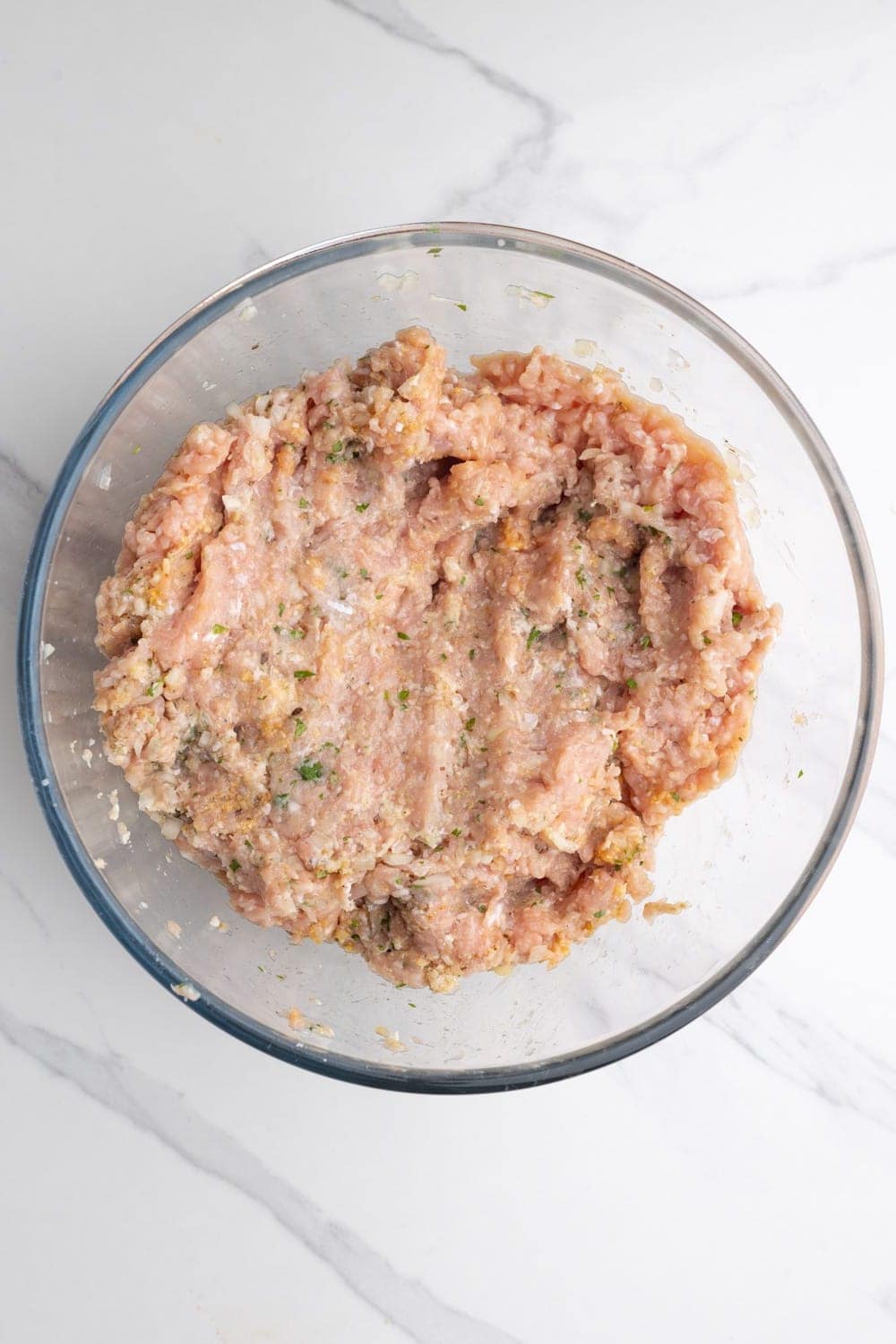raw chicken meatloaf mixed in a bowl.