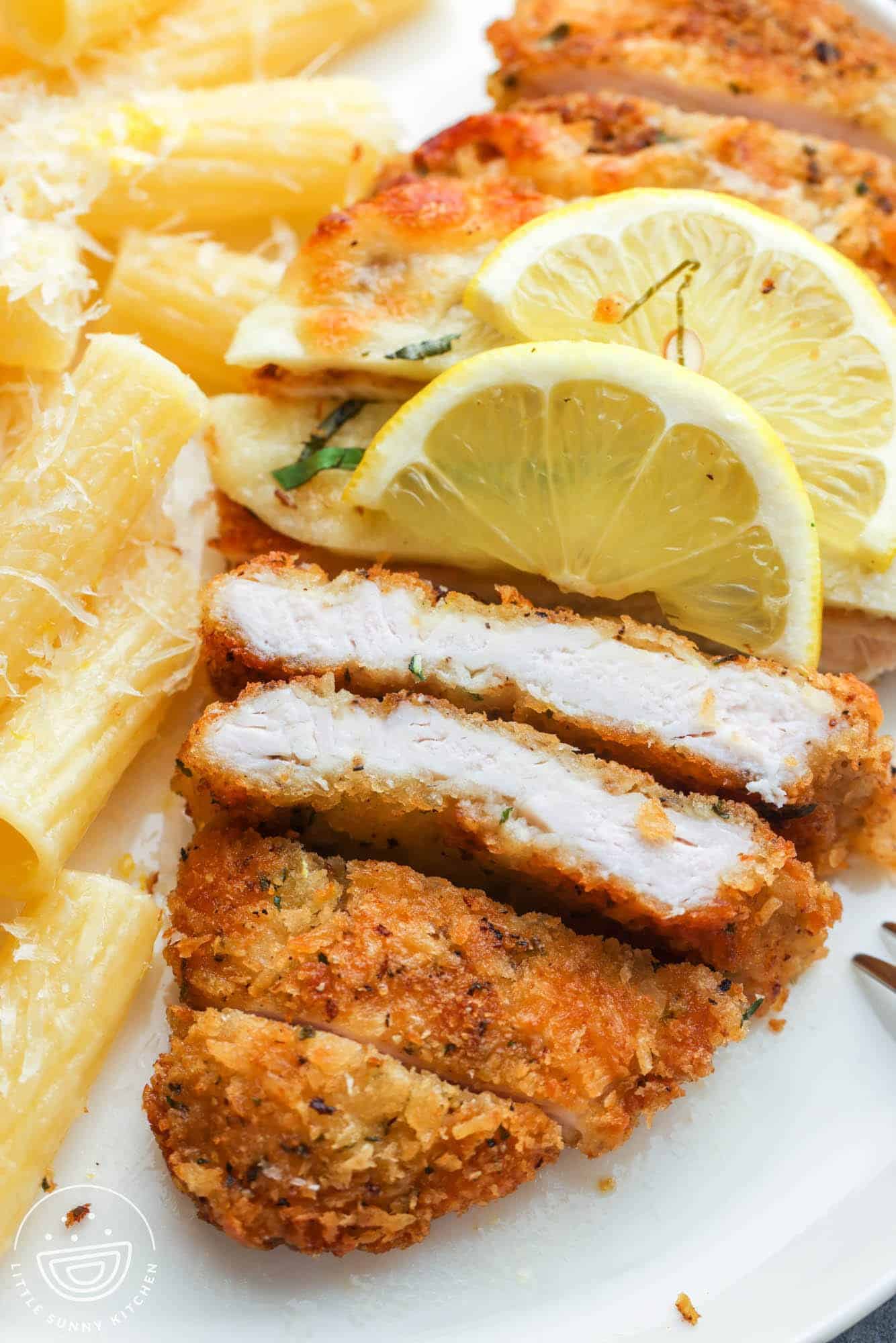 crispy romano crusted chicken sliced to show a perfectly cooked interior