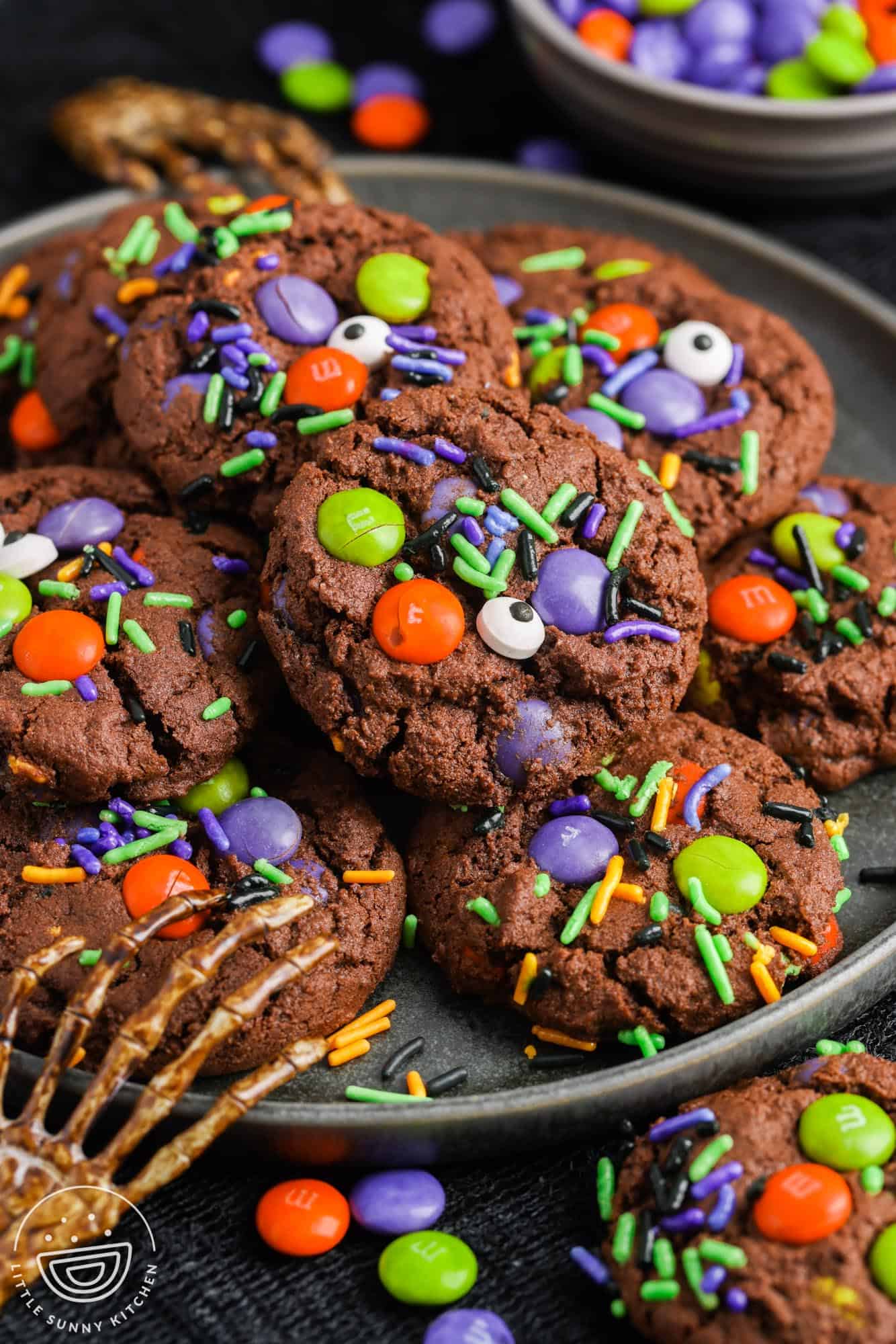 a gray plate holding halloween cookies.