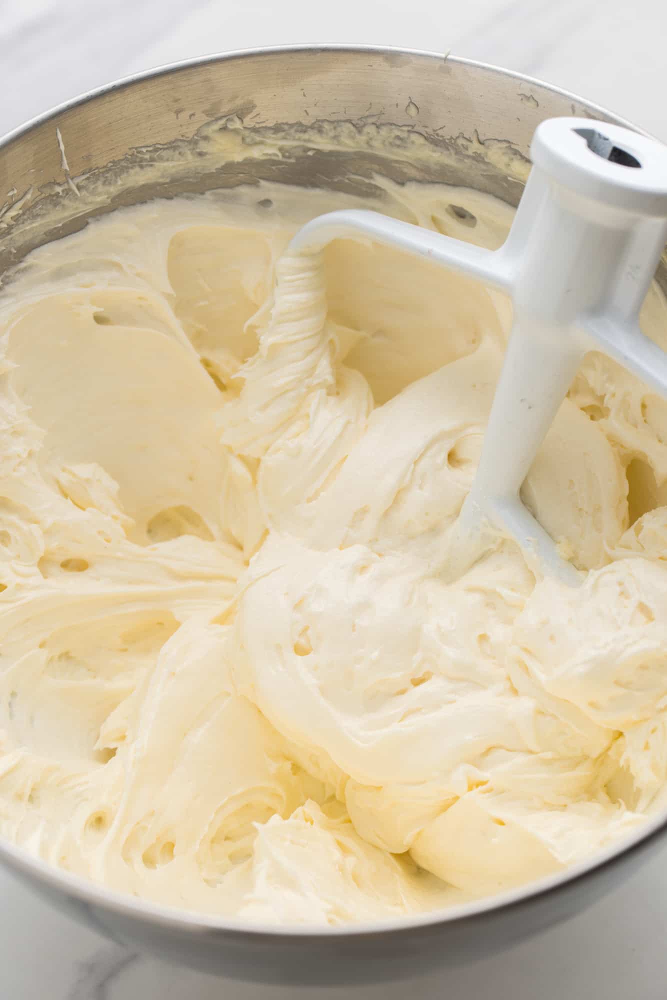 whipped cream cheese filling in a mixing bowl.