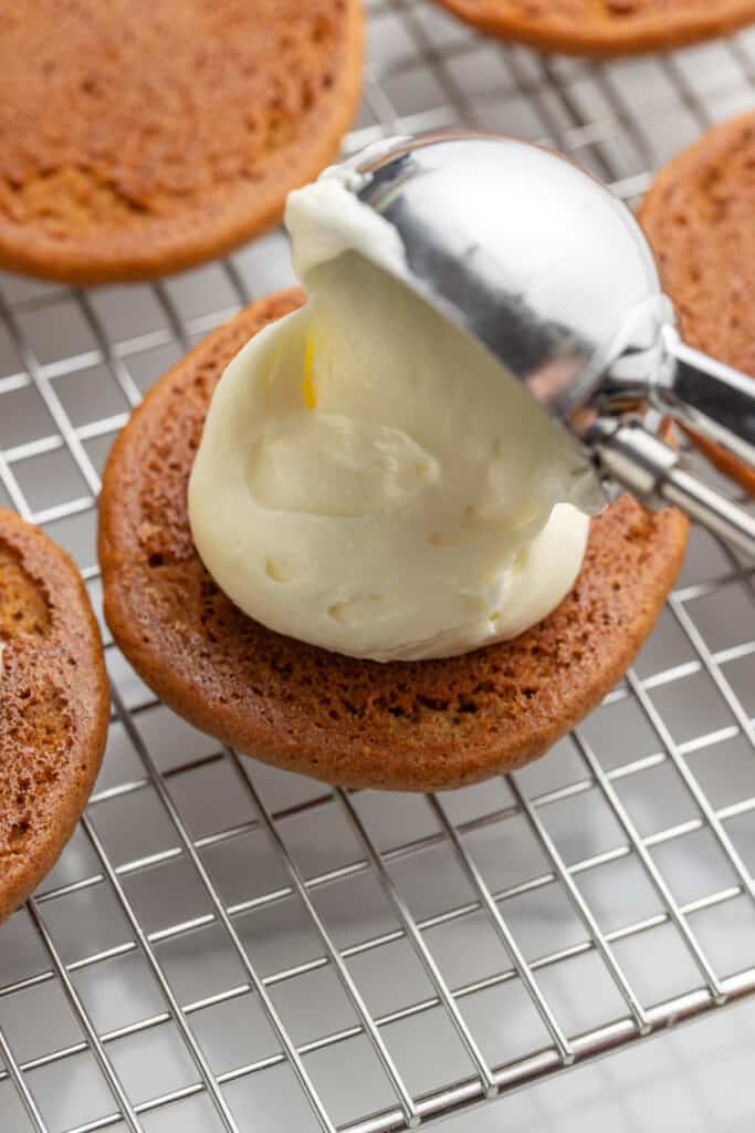 creamy filling added to whoopie pies with a cookie scoop