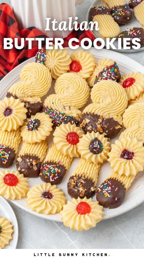 a plate of italian butter cookies decorated with melted chocolate, sprinkles, and cherries. Text overlay says "Italian Butter Cookies"
