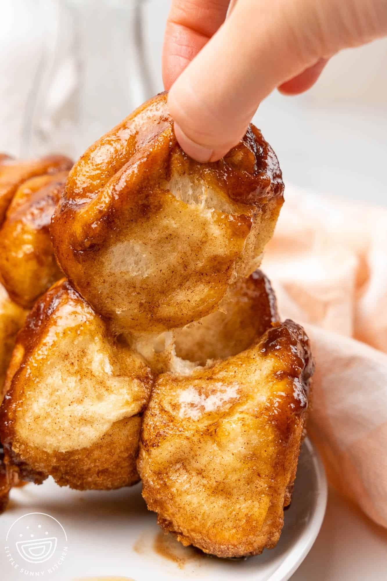 Pulling out a piece of monkey bread from the cake