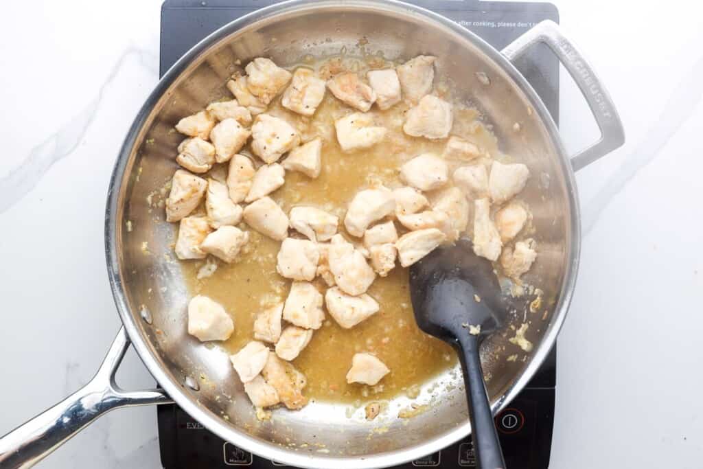 bite sized pieces of chicken cooked in a skillet.