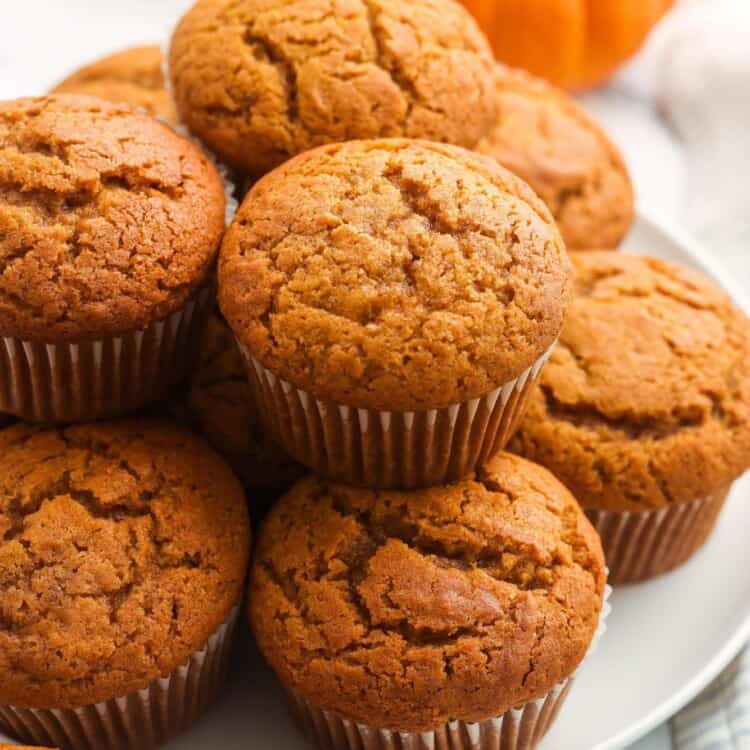 pumpkin banana muffins stacked on a plate