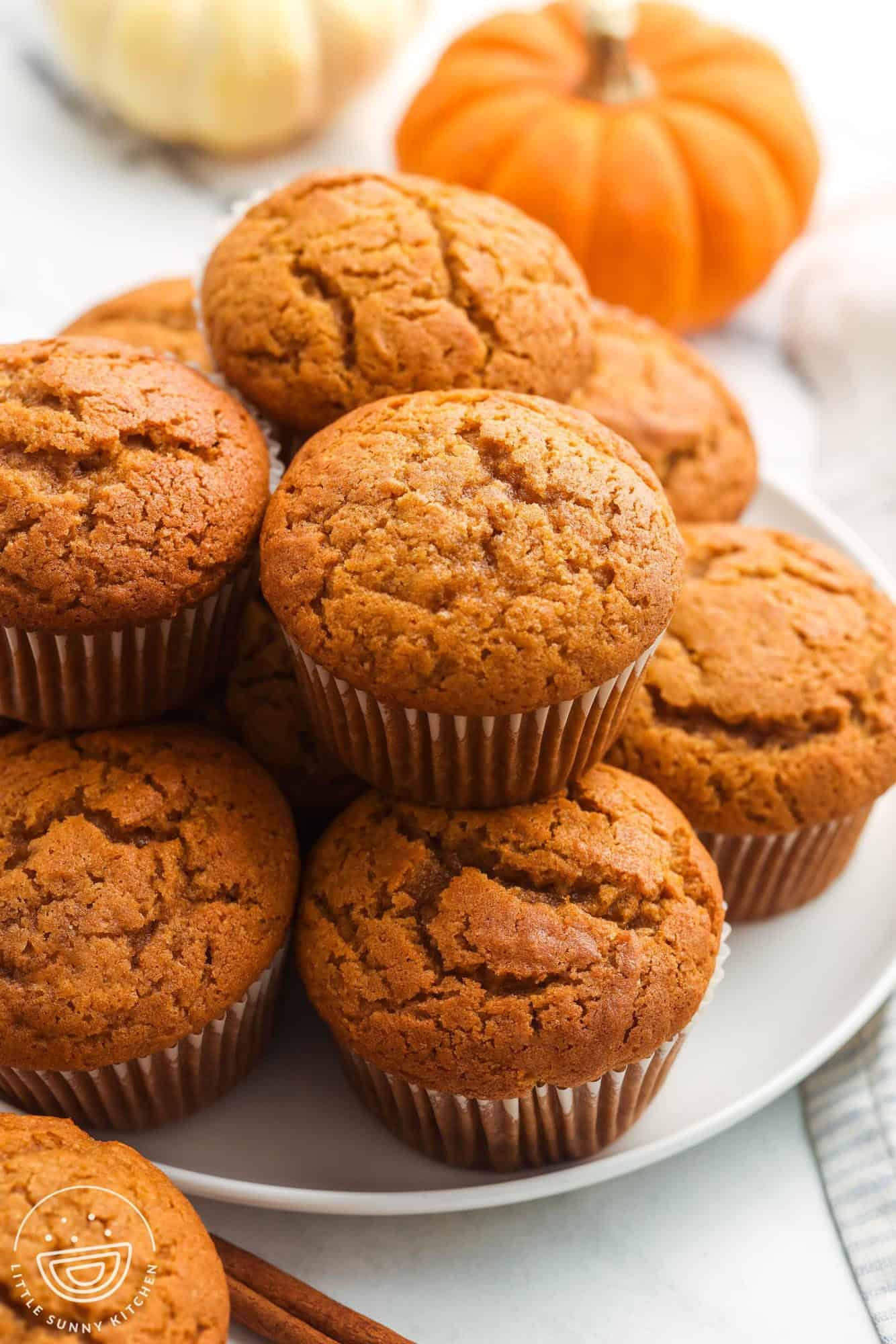 pumpkin banana muffins stacked on a plate