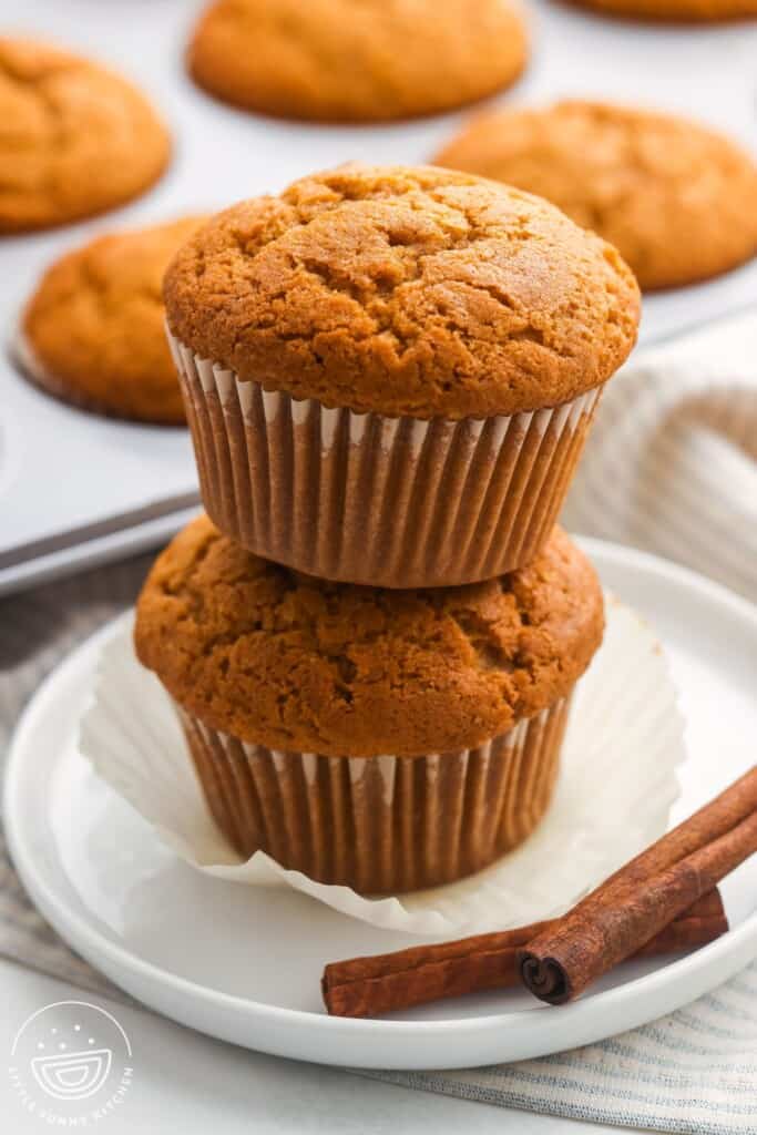 two banana pumpkin muffins stacked on top of each other.