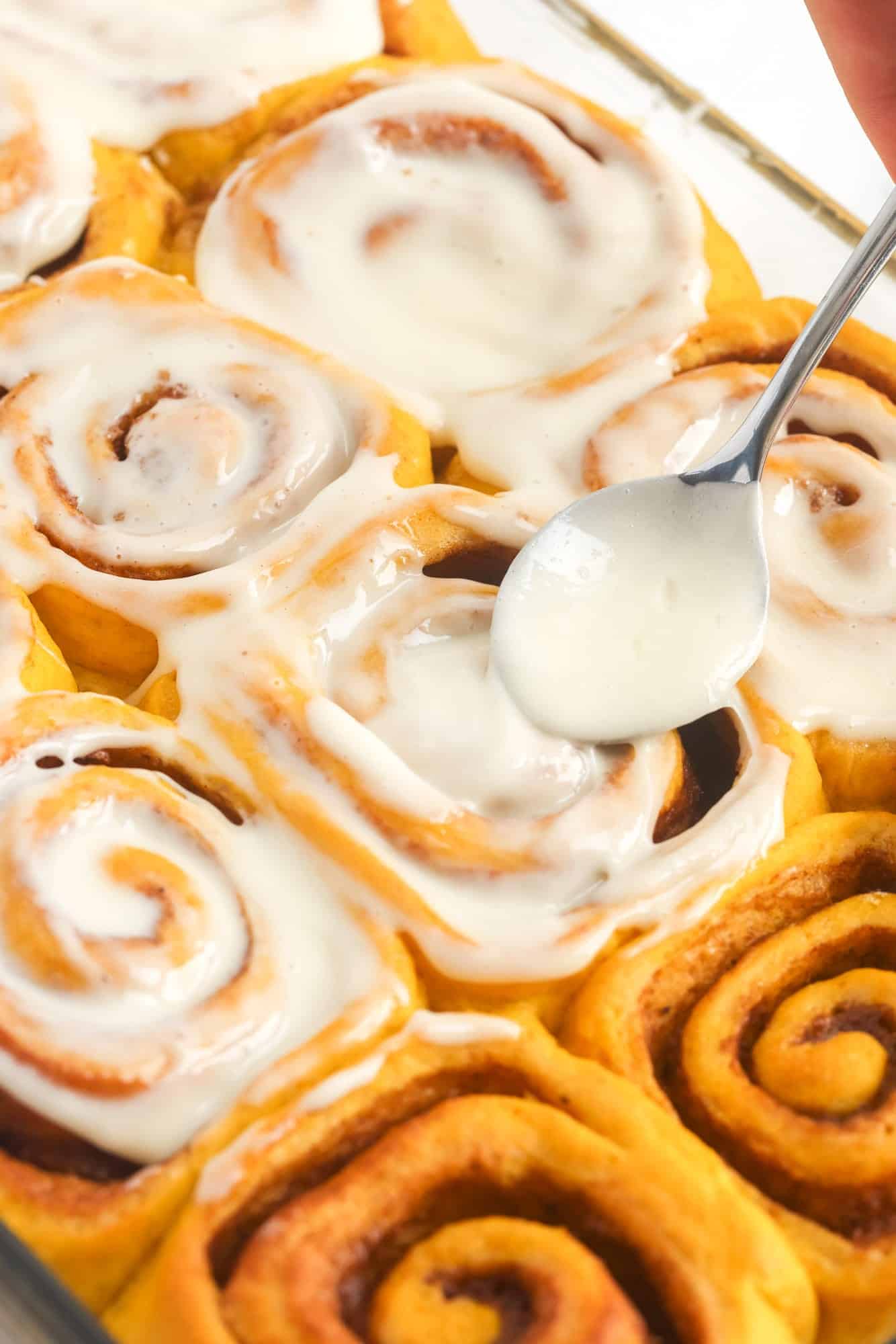 how to spread icing over pumpkin cinnamon rolls with a spoon