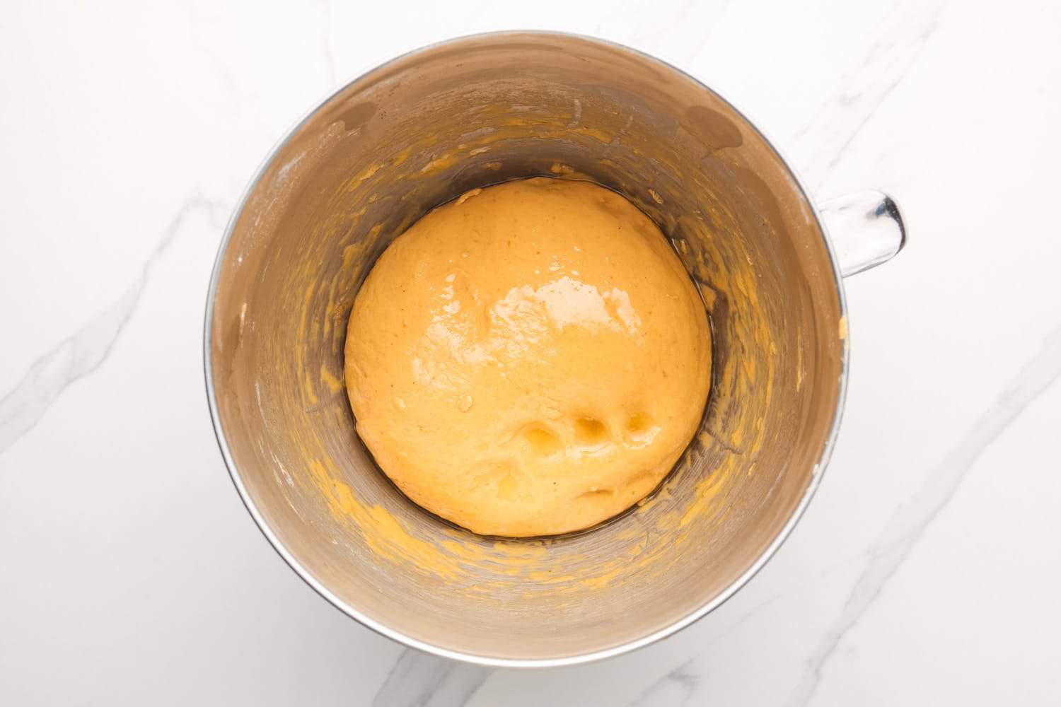 oiled pumpkin yeast dough in a mixing bowl, before the first rise.