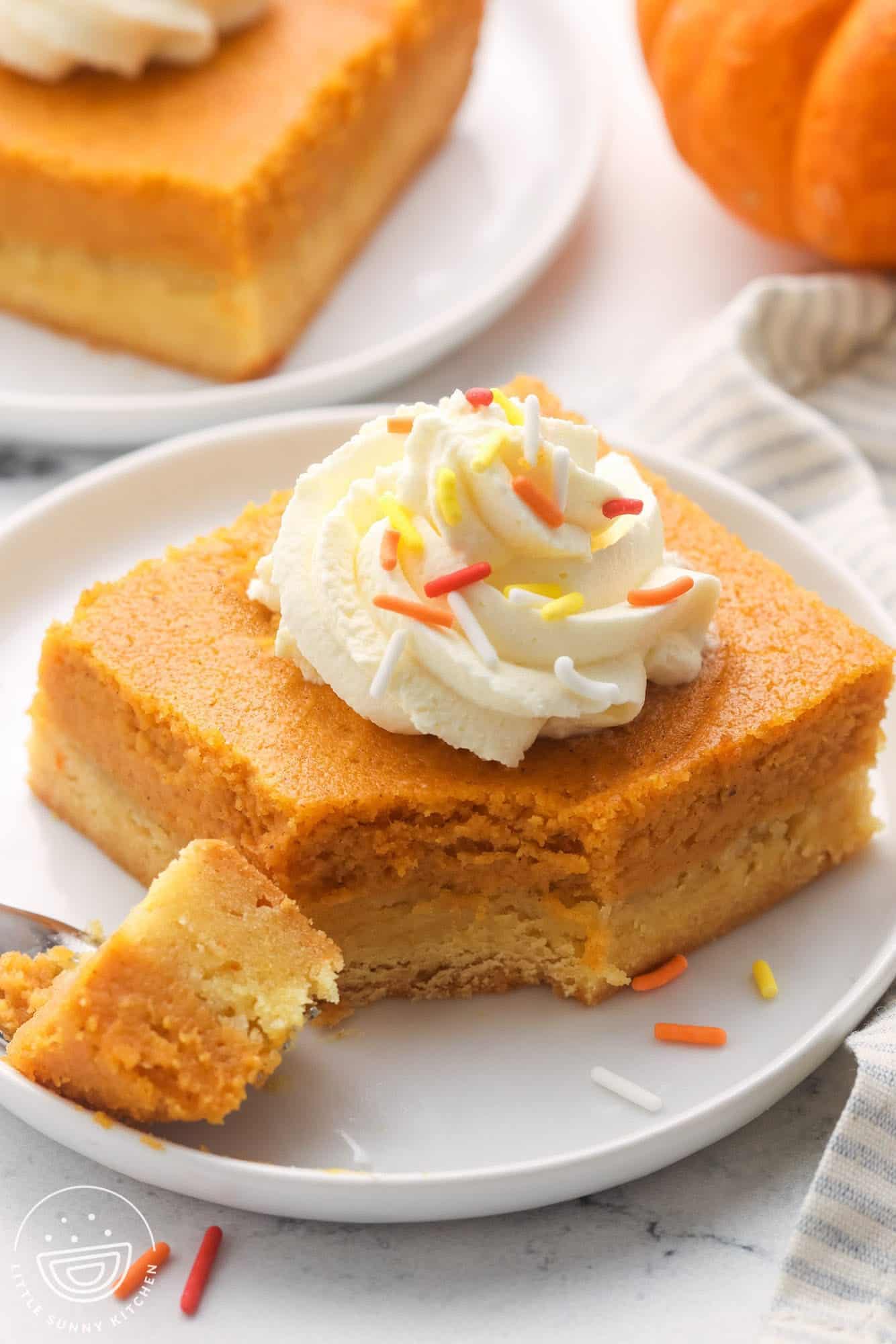 a serving of pumpkin butter cake with a bite taken from one corner.