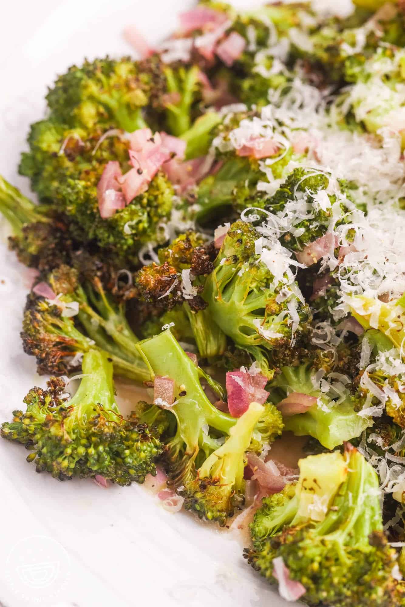 Close up shot of roasted broccoli with shallot and parmesan