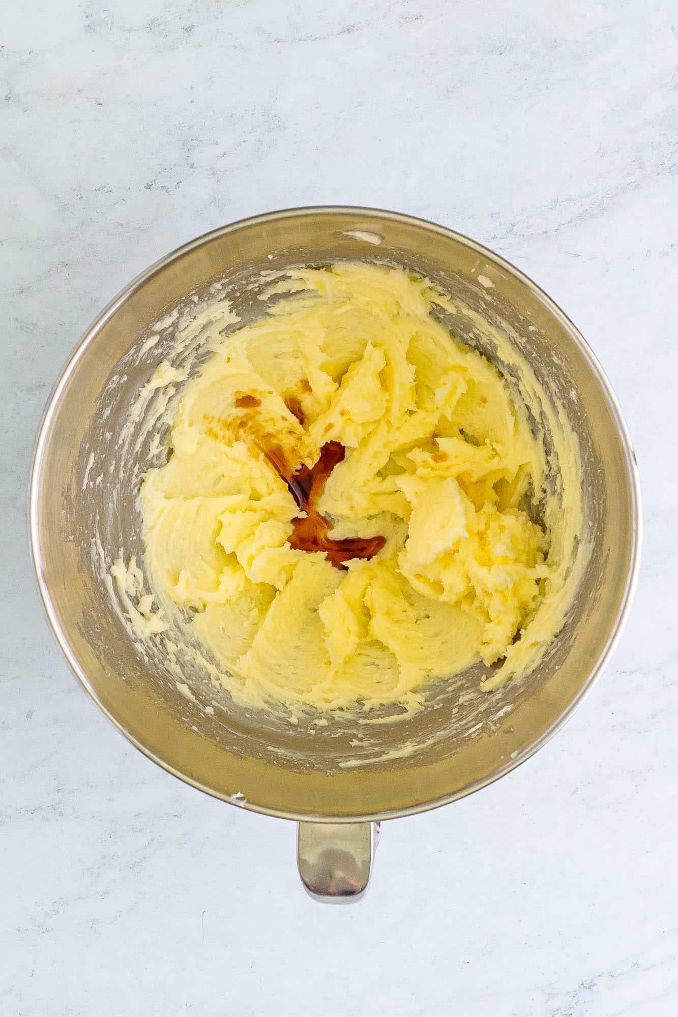 butter and sugar creamed in a mixing bowl with vanilla added