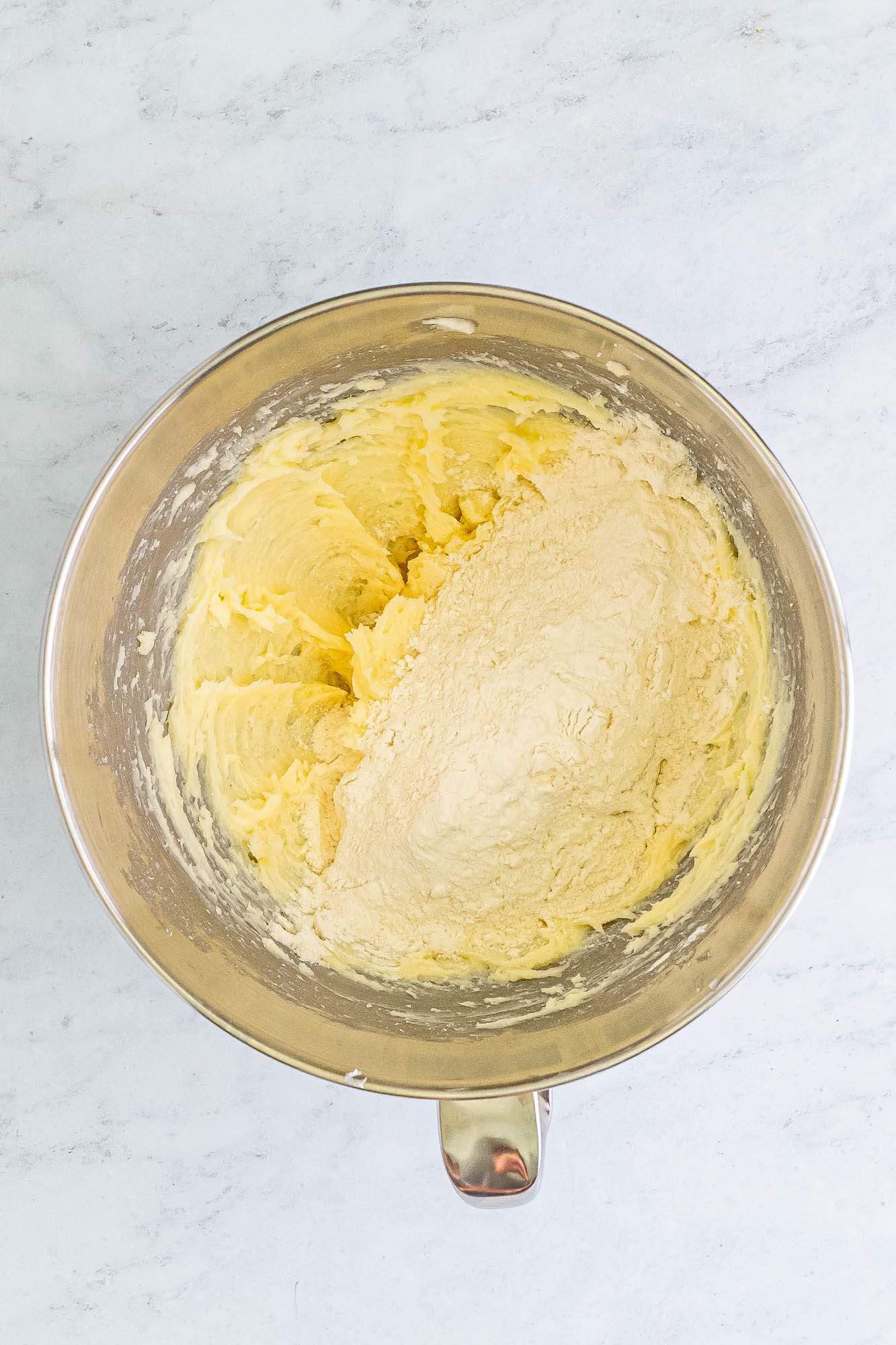 flour added to butter in a mixing bowl.