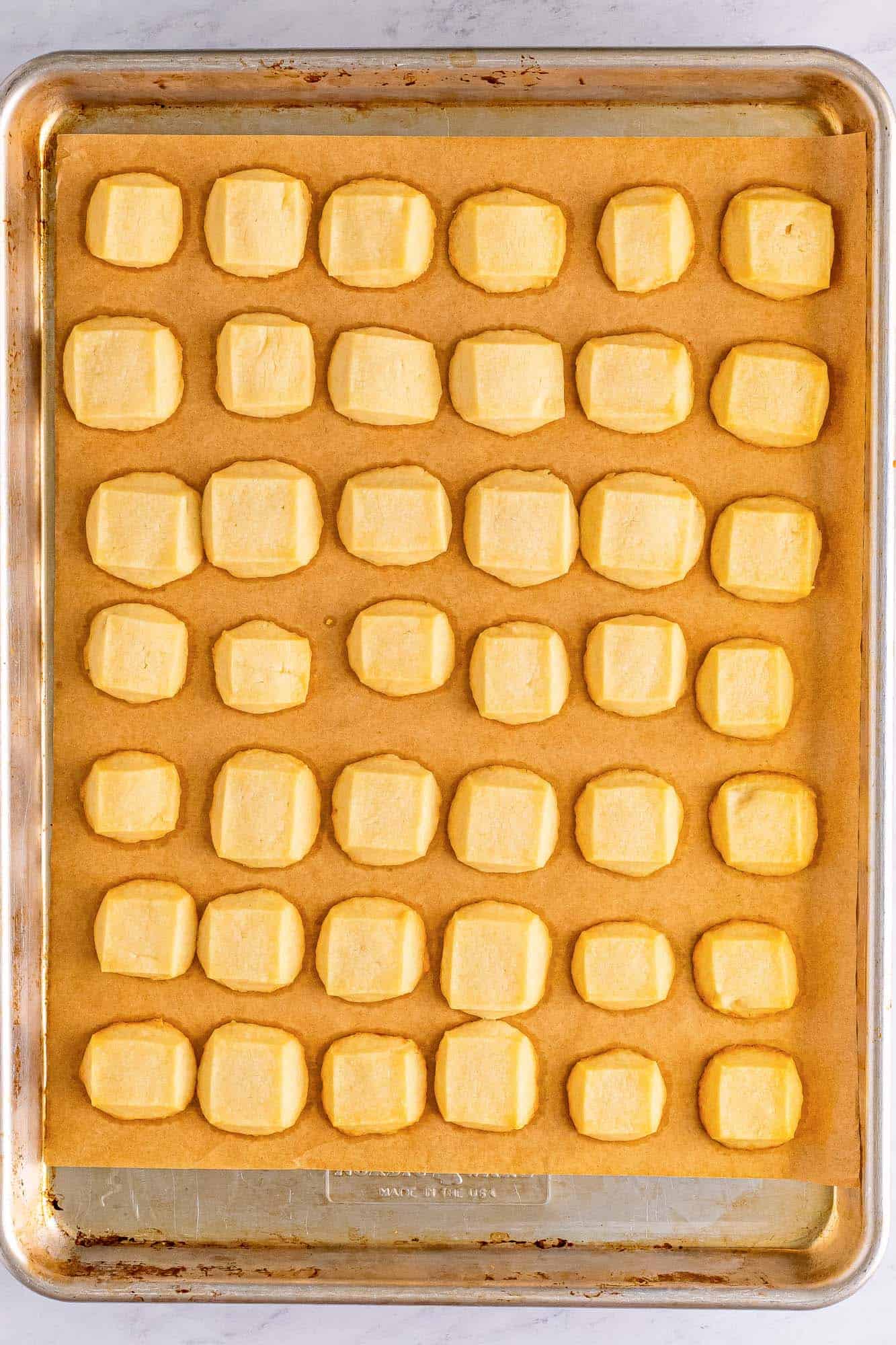 baked shortbread bites on a cookie sheet.