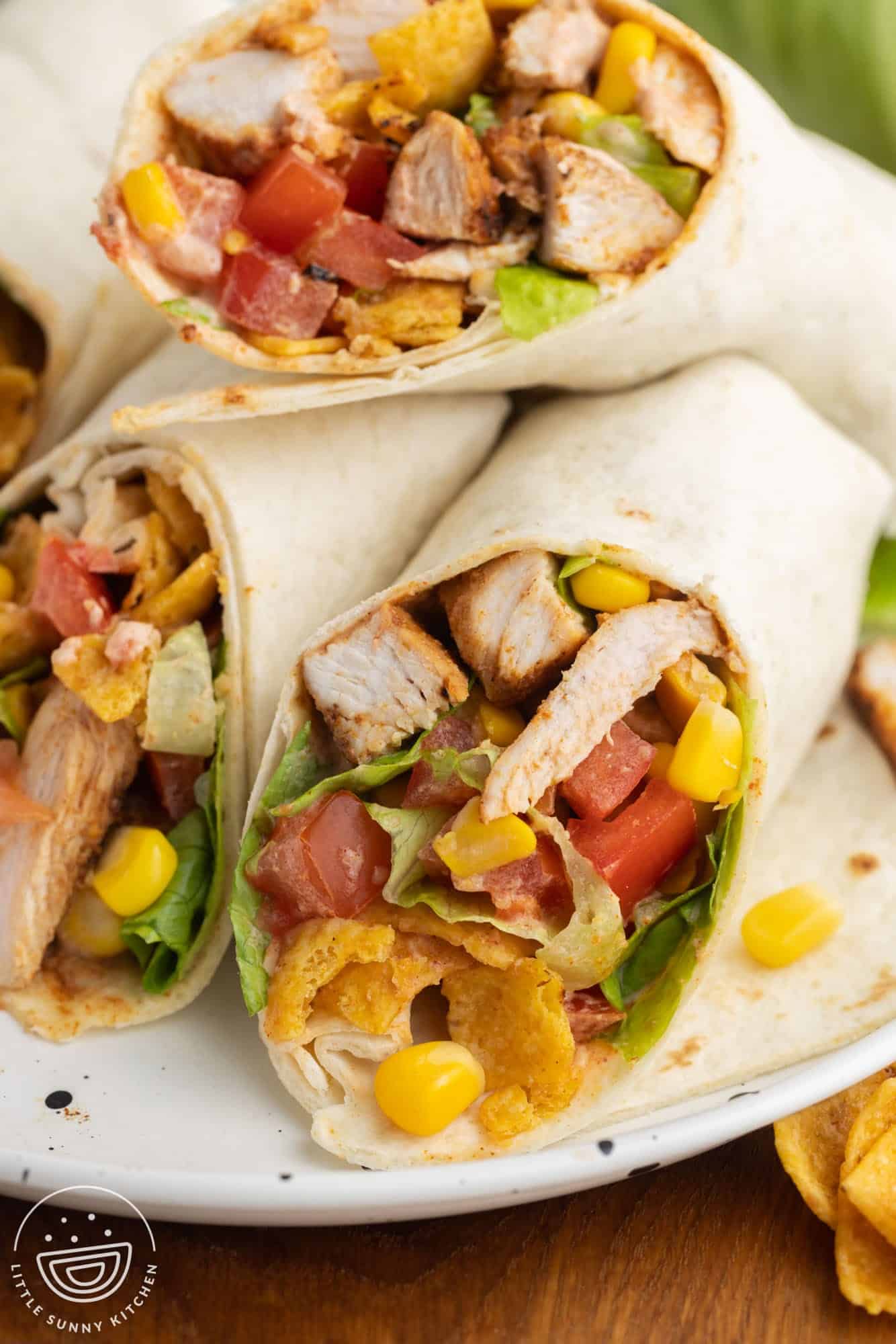 chicken wraps with southwest flair stacked on a plate. 