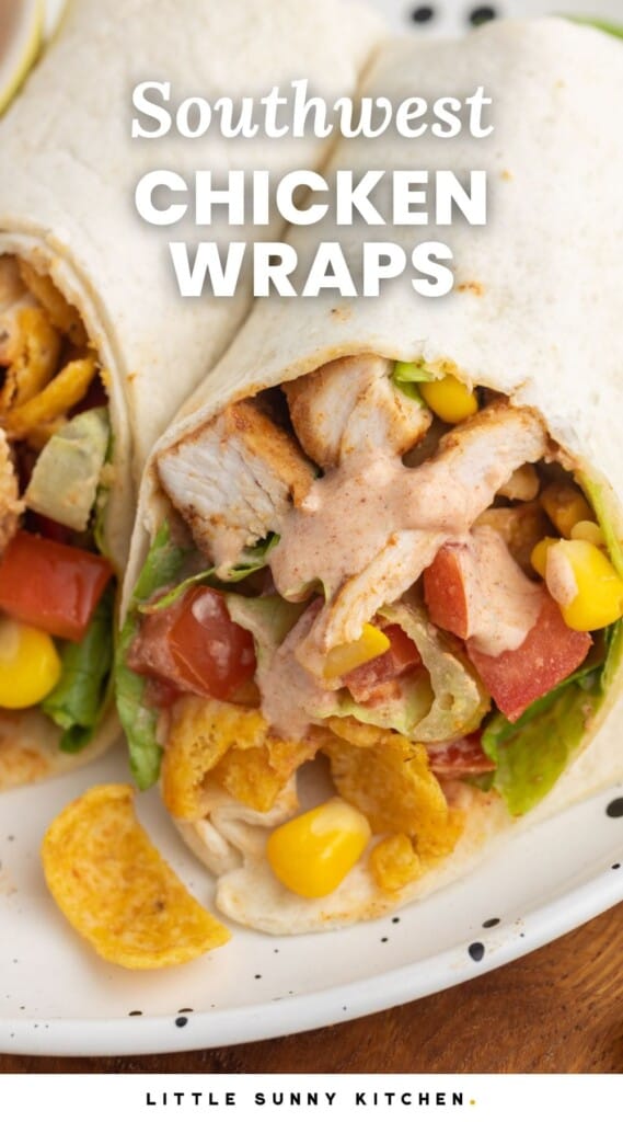 A wrap cut in half on a plate, filled with chicken, veggies, and fritos chips.