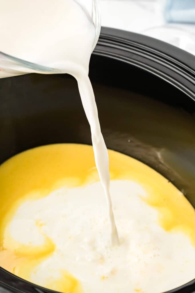 cream added to a crock pot to make eggnog.