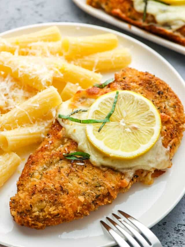a dinner plate of chicken romano and pasta.