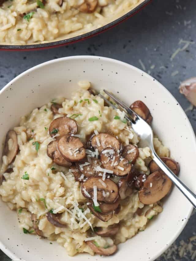 Overhead shot of mushroom risotto in a bowl with a fork