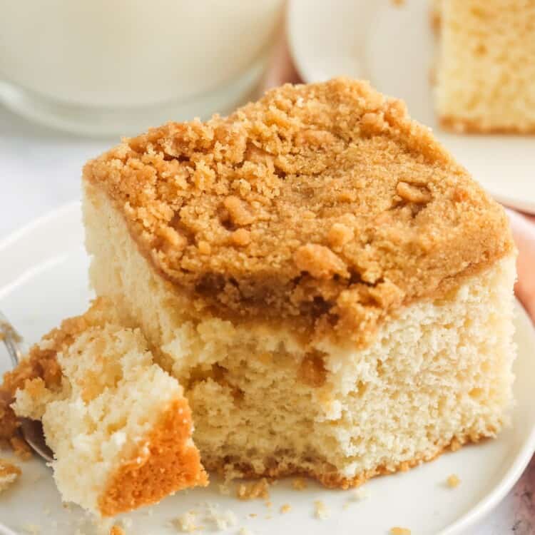 a serving of coffee cake with a bite taken.