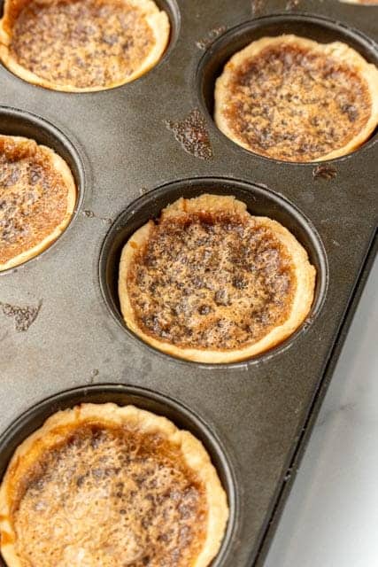 baked butter tarts in a pan.