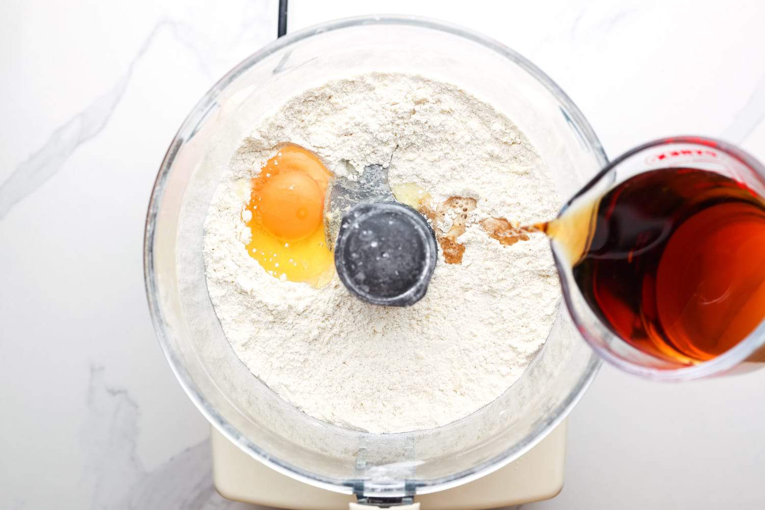 wine and egg added to flour in a food processor. 