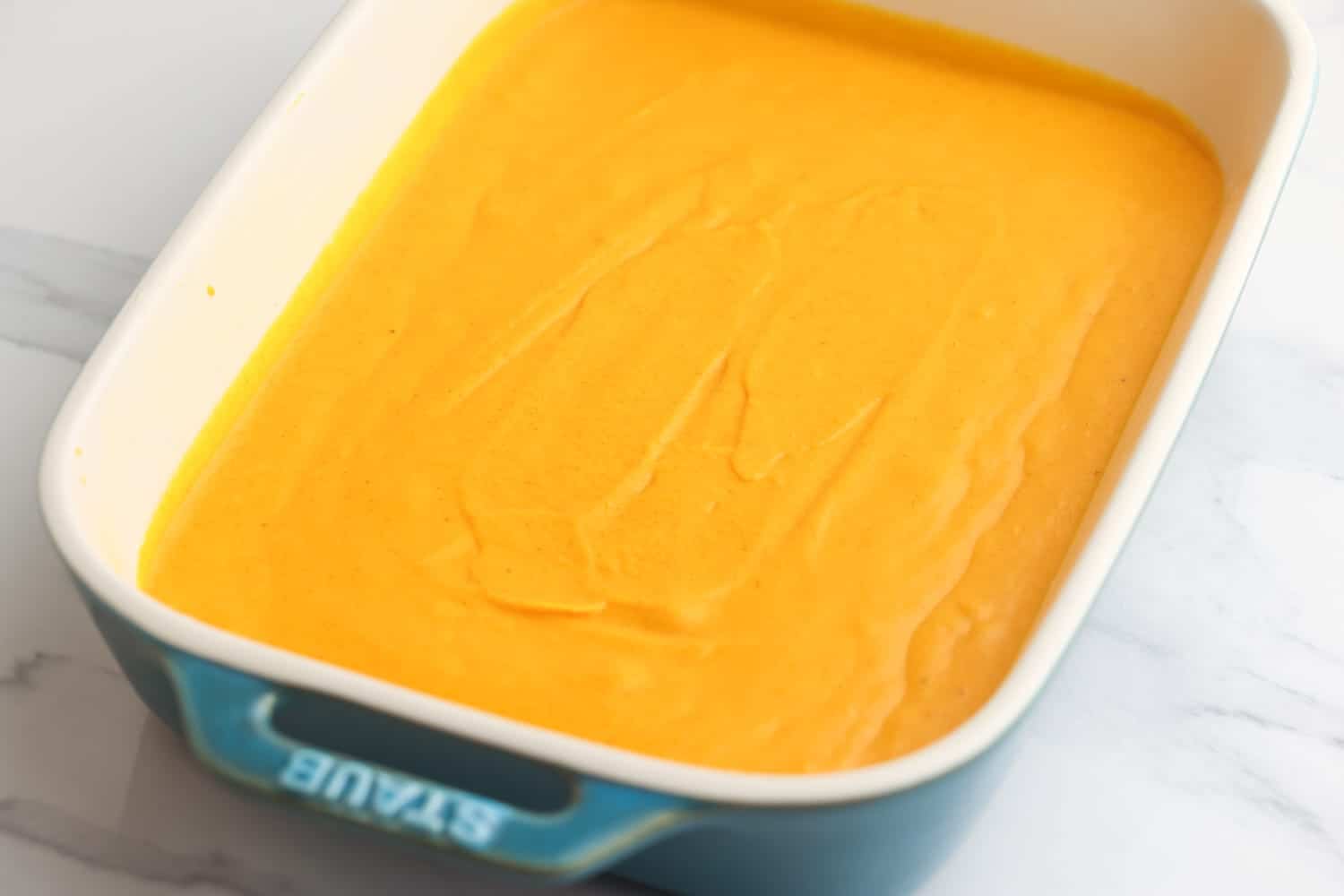 Carrot souffle mixture in a baking dish before baking