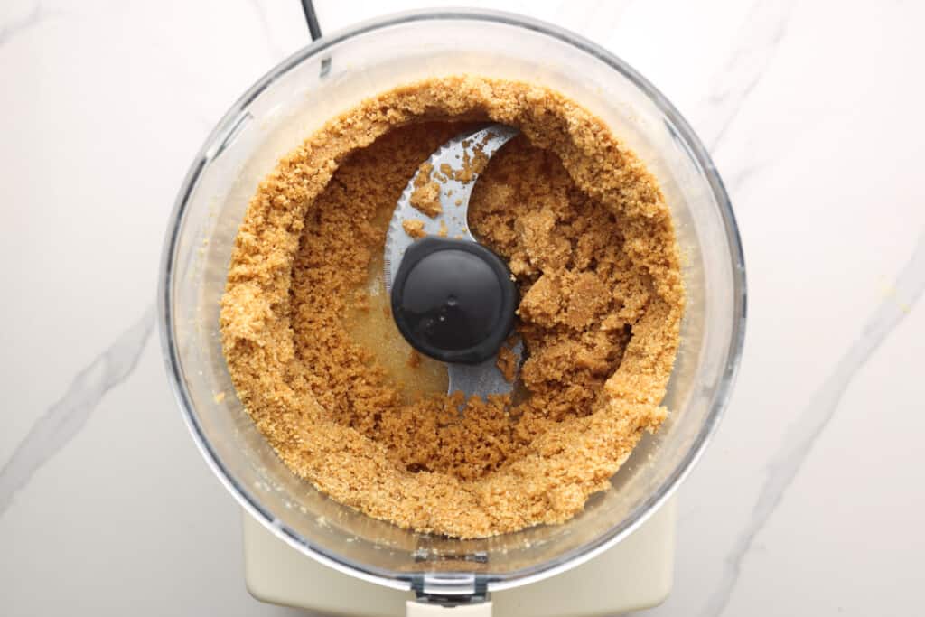 making graham cracker crust in a food processor.