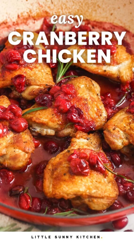 chicken thighs in a red cranberry sauce in a skillet. Text overlay says "easy cranberry chicken"