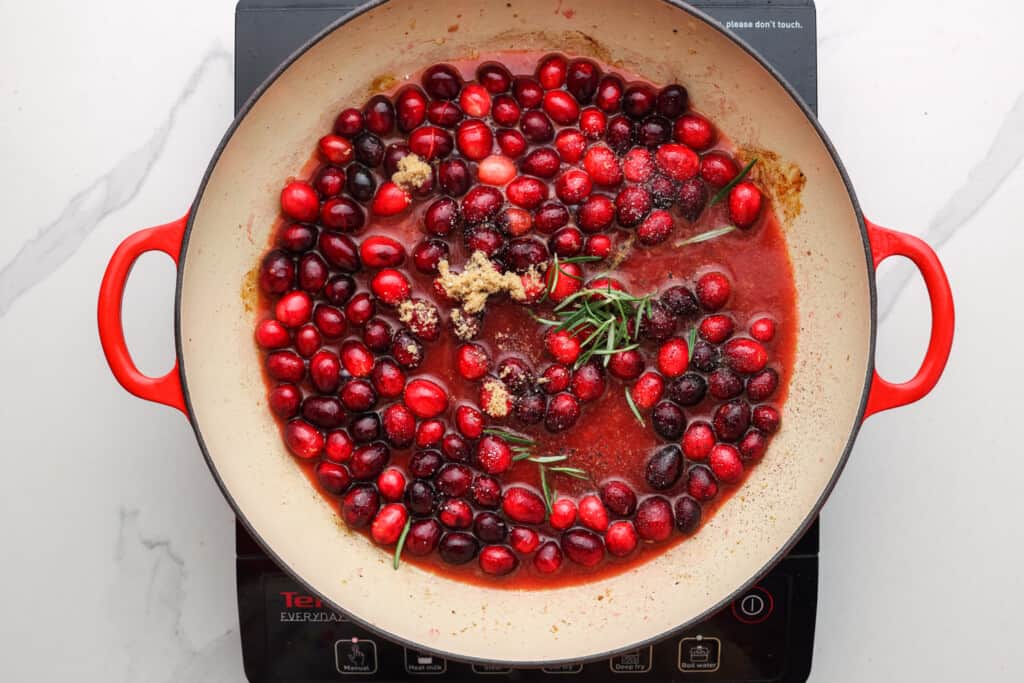 fresh cranberries, rosemary, and brown sugar in a skillet to create a sauce.