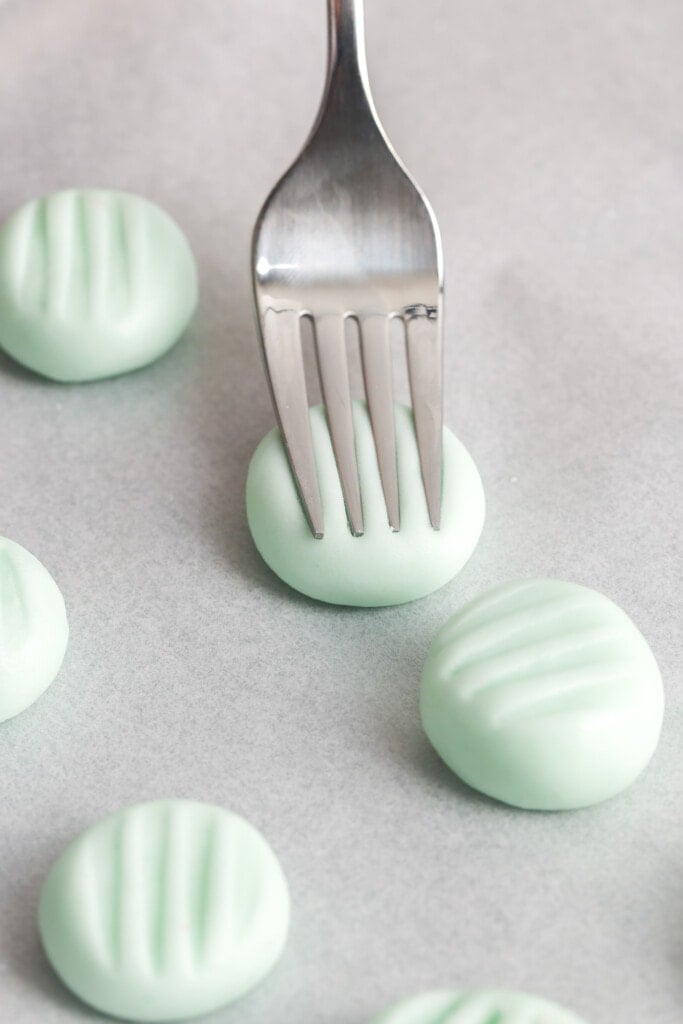 using a fork to press cream cheese mints