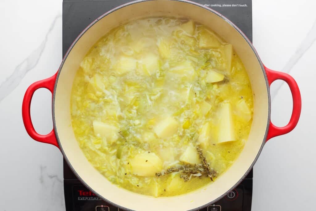 potatoes and leeks simmering in a pot.