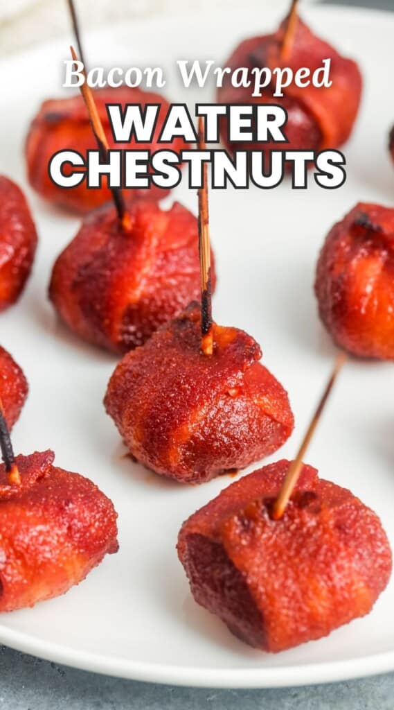 a white plate holding baked chestnuts marinated in red sauce and wrapped with bacon. Text overlay says "bacon wrapped water chestnuts"