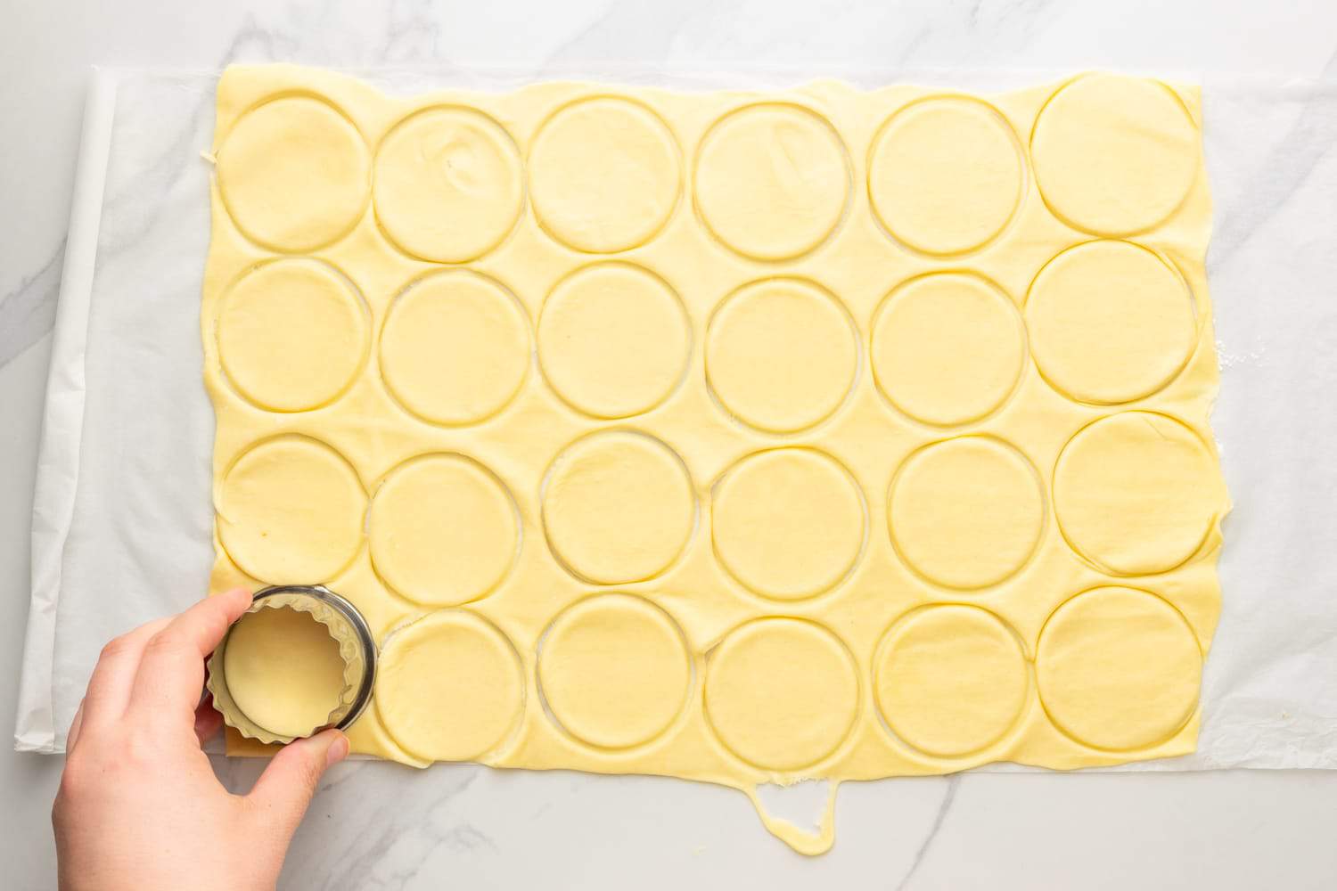 a rectangle of pie crust pastry cut into circles with a biscuit cutter. 