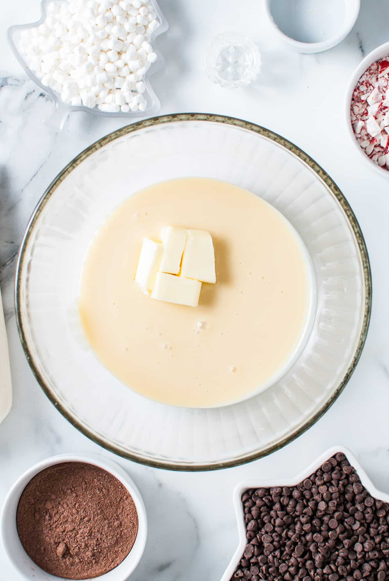 a glass bowl of sweetened condensed milk and butter. 