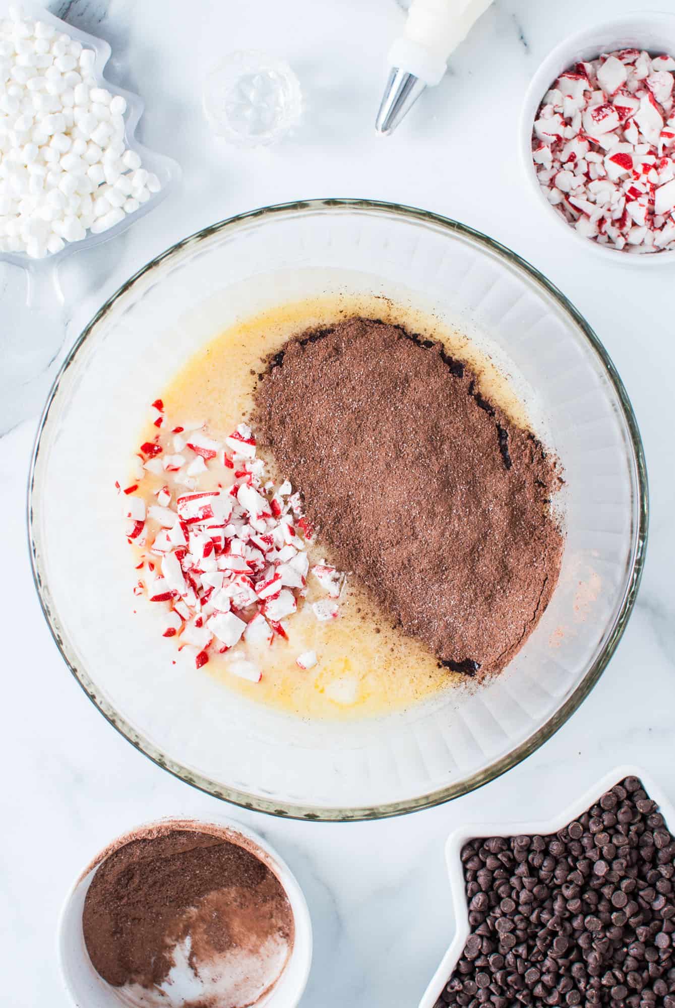 crushed peppermints and hot cocoa mix added to a bowl of hot condensed milk. 