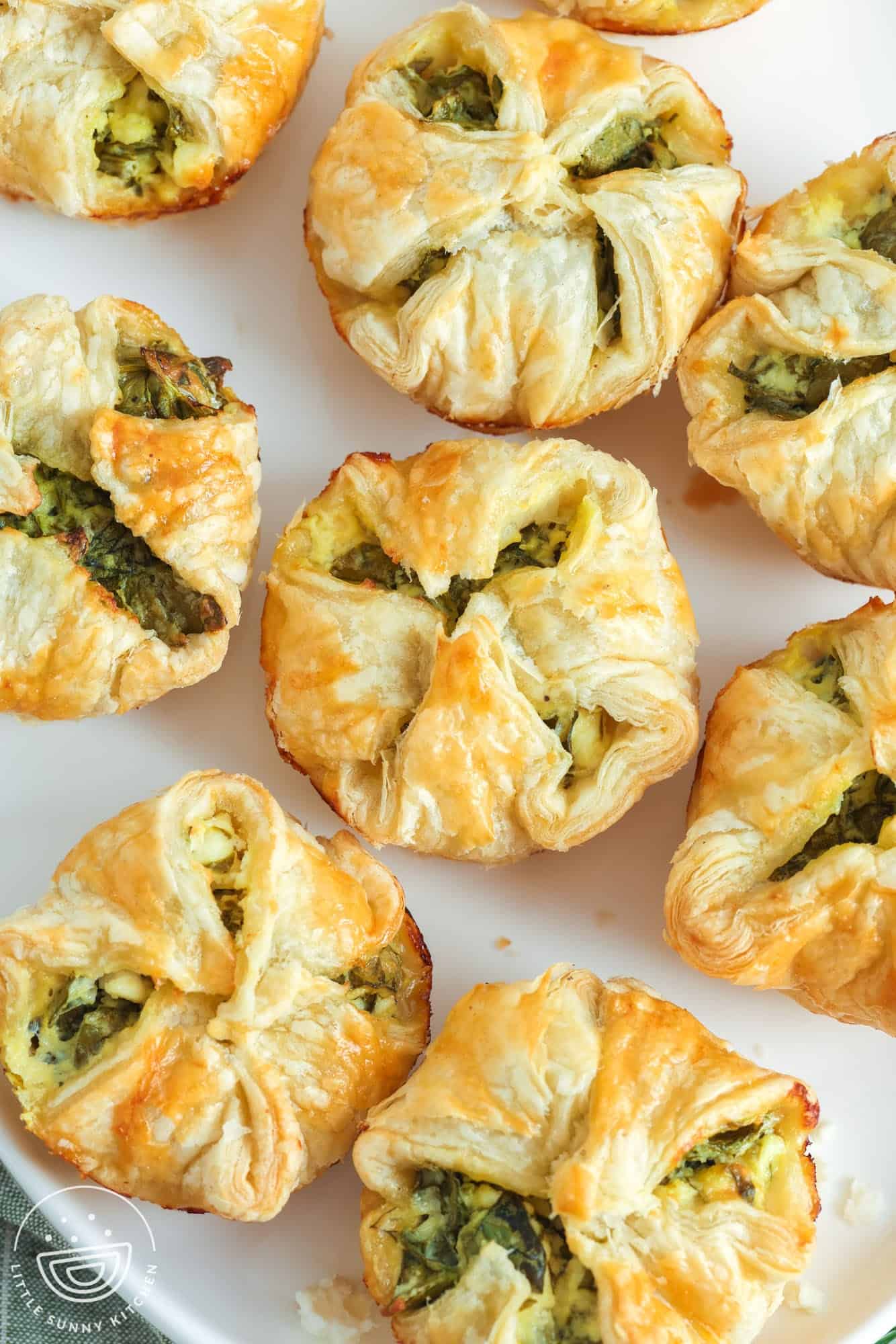 a platter of spinach puffs, viewed from above.