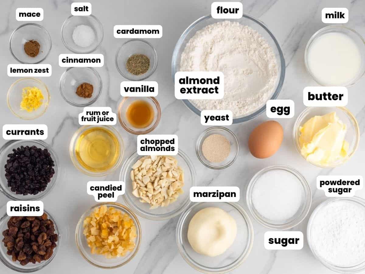 All of the ingredients needed to make stollen, measured into small bowls and arranged on a counter. 