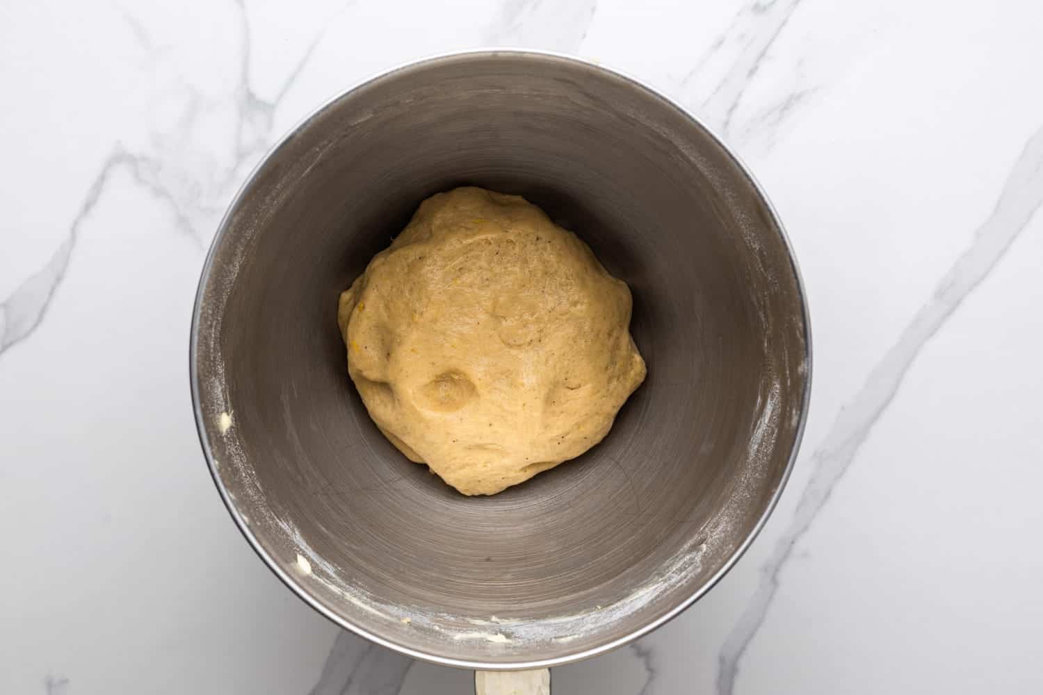 stollen dough in the metal bowl of a stand mixer.