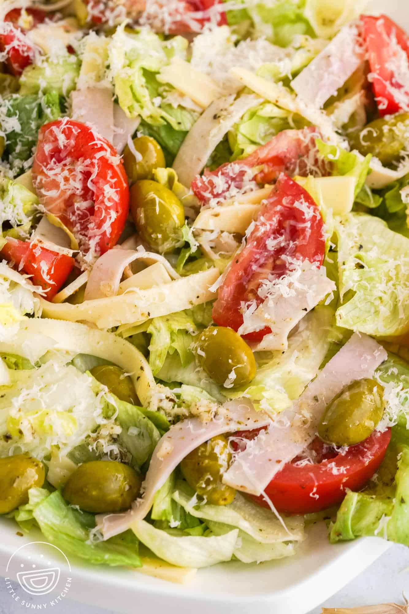 closeup of a freshly made 1905 salad with olives and tomatoes.