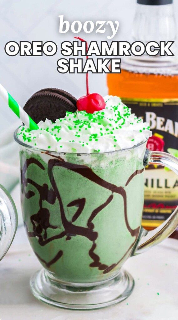 Boozy Oreo Shamrock Shake in a glass mug, topped with whipped cream, a cherry, and sprinkles. And overlay text that says "Boozy Oreo shamrock shake"