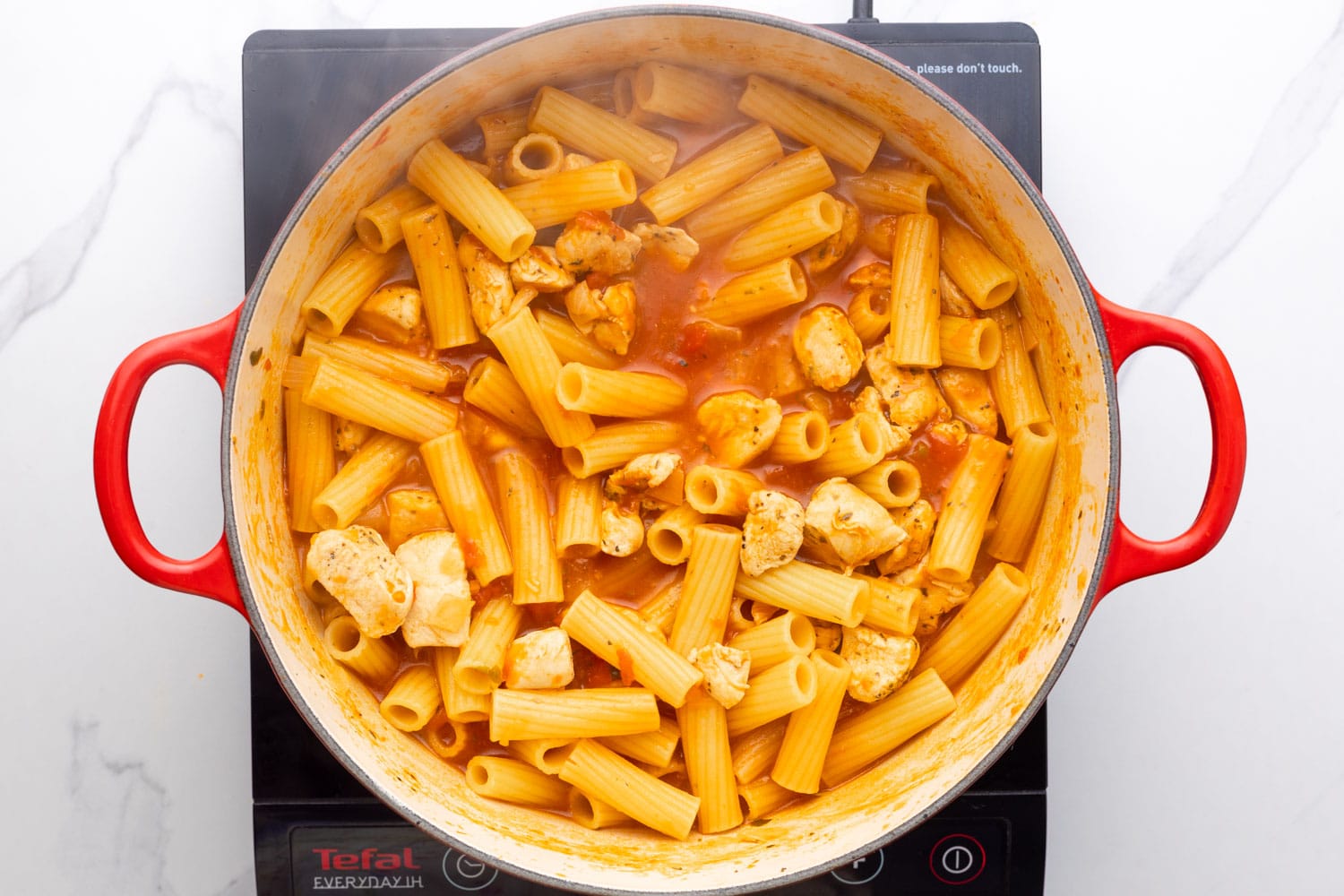 pasta that has been cooked in a dutch oven with broth and tomatoes. 
